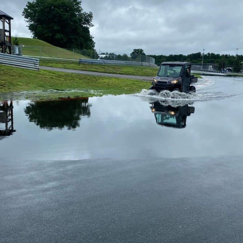 Gator driving thru lake on track